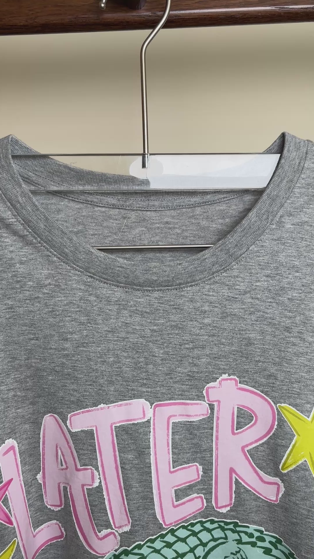 Grey Later Gator graphic t-shirt hanging on clothing rack.